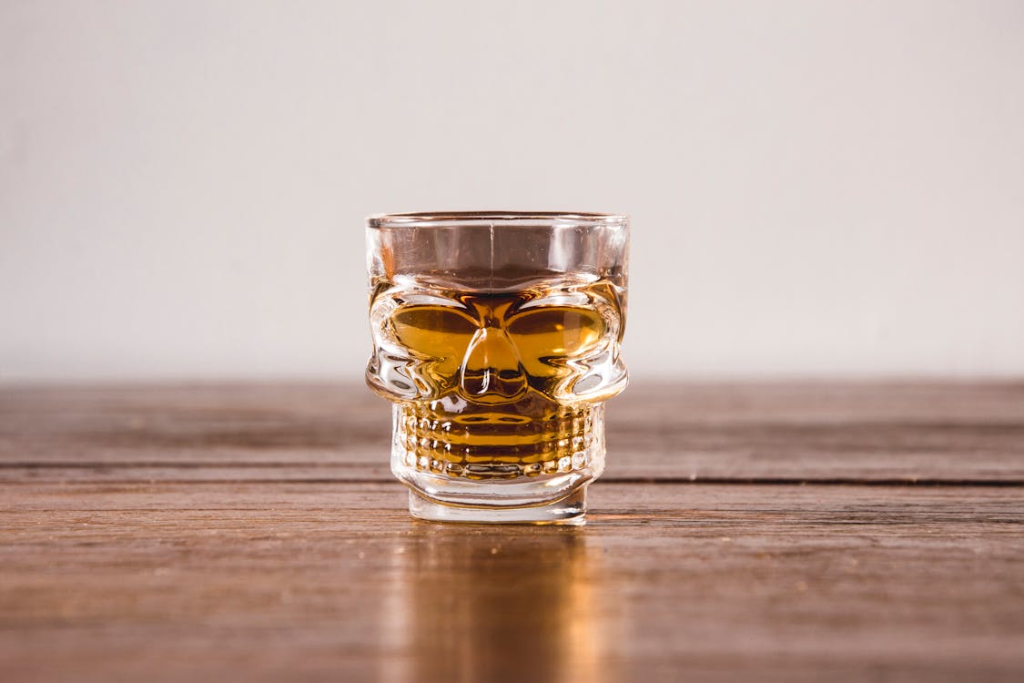 Free Clear Shot Glass With Yellow Liquid Stock Photo
