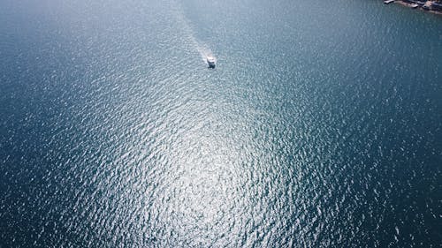 rippling sea water with boat on sunny day