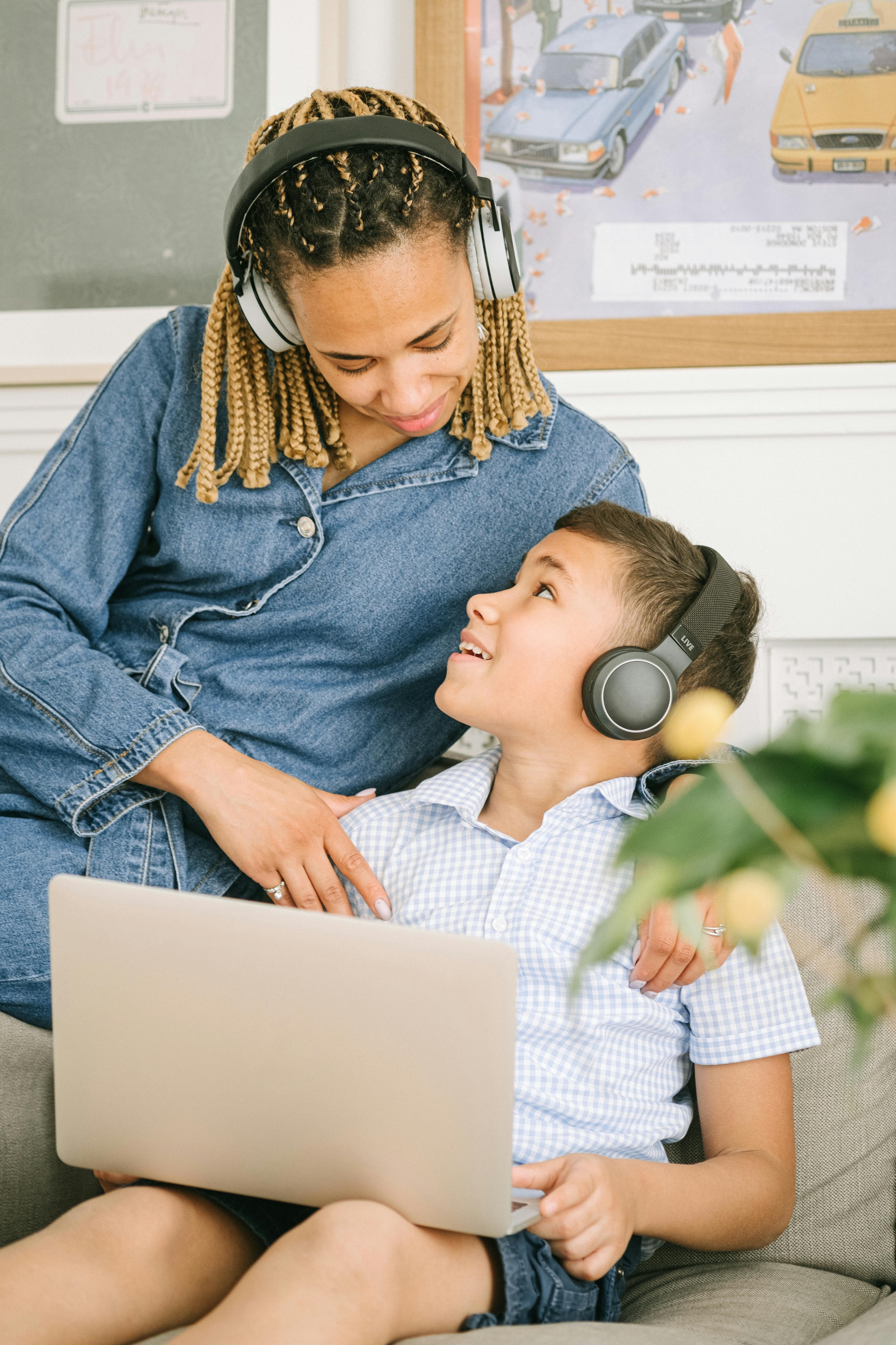 man in blue denim button up shirt using white and gray headphones