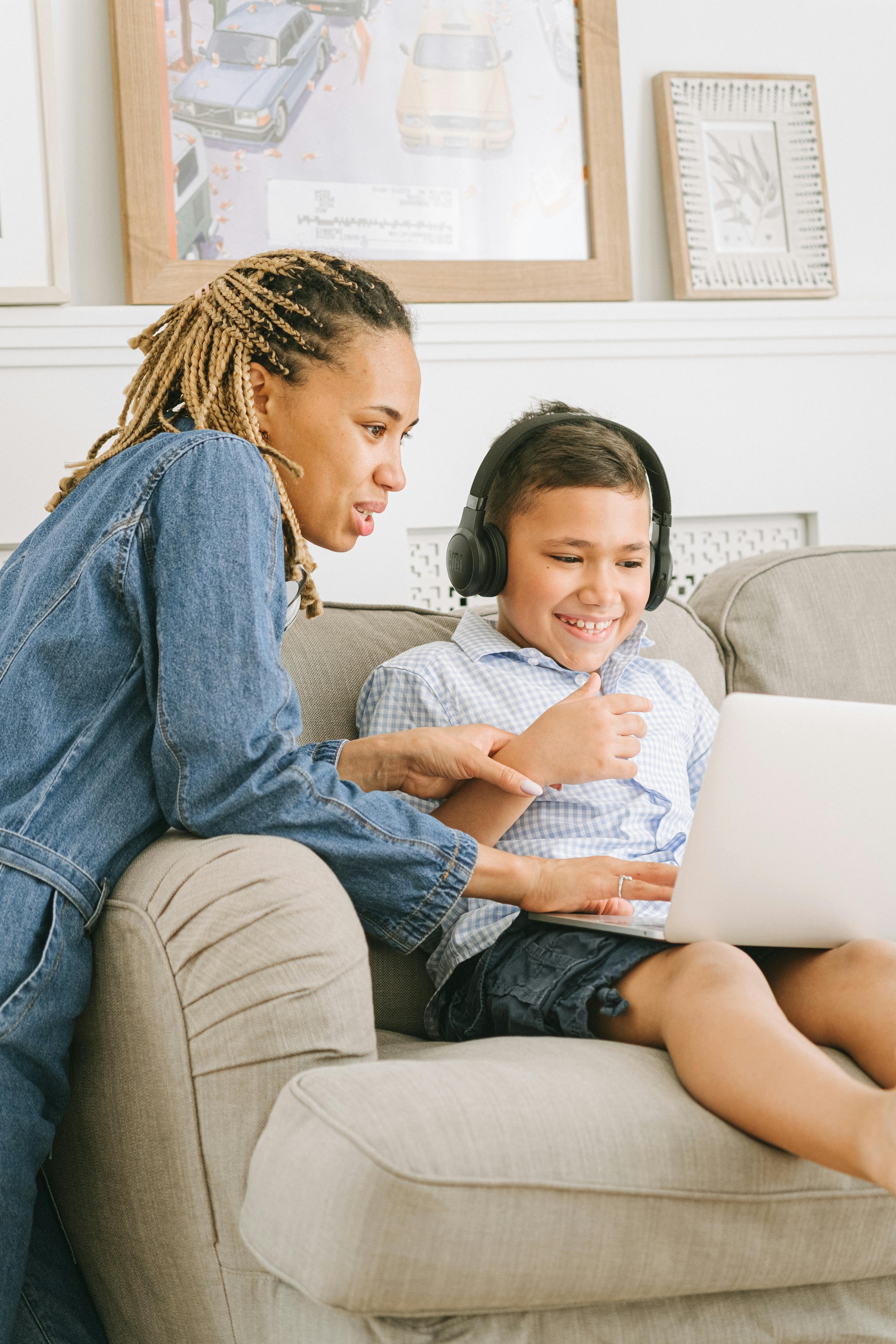 boy with headphones sitting on sofa