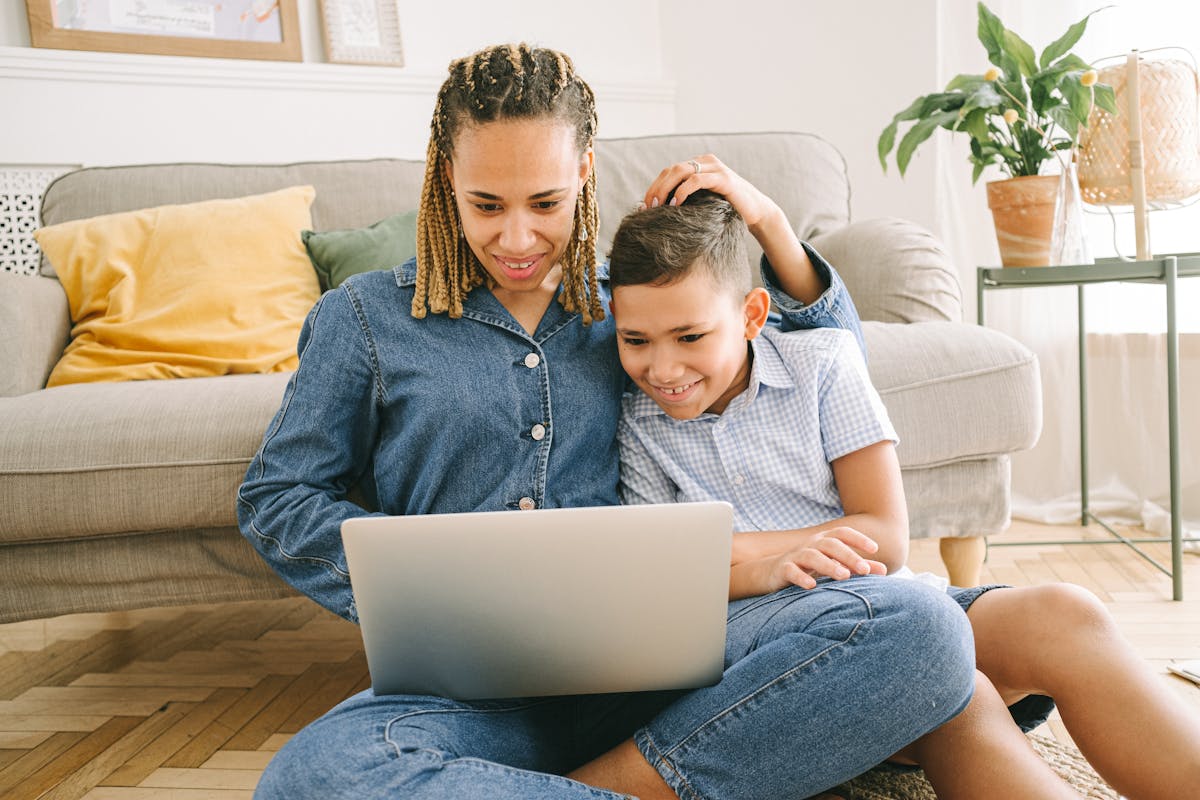 Mother and son sitting on floor learning children’s social skills