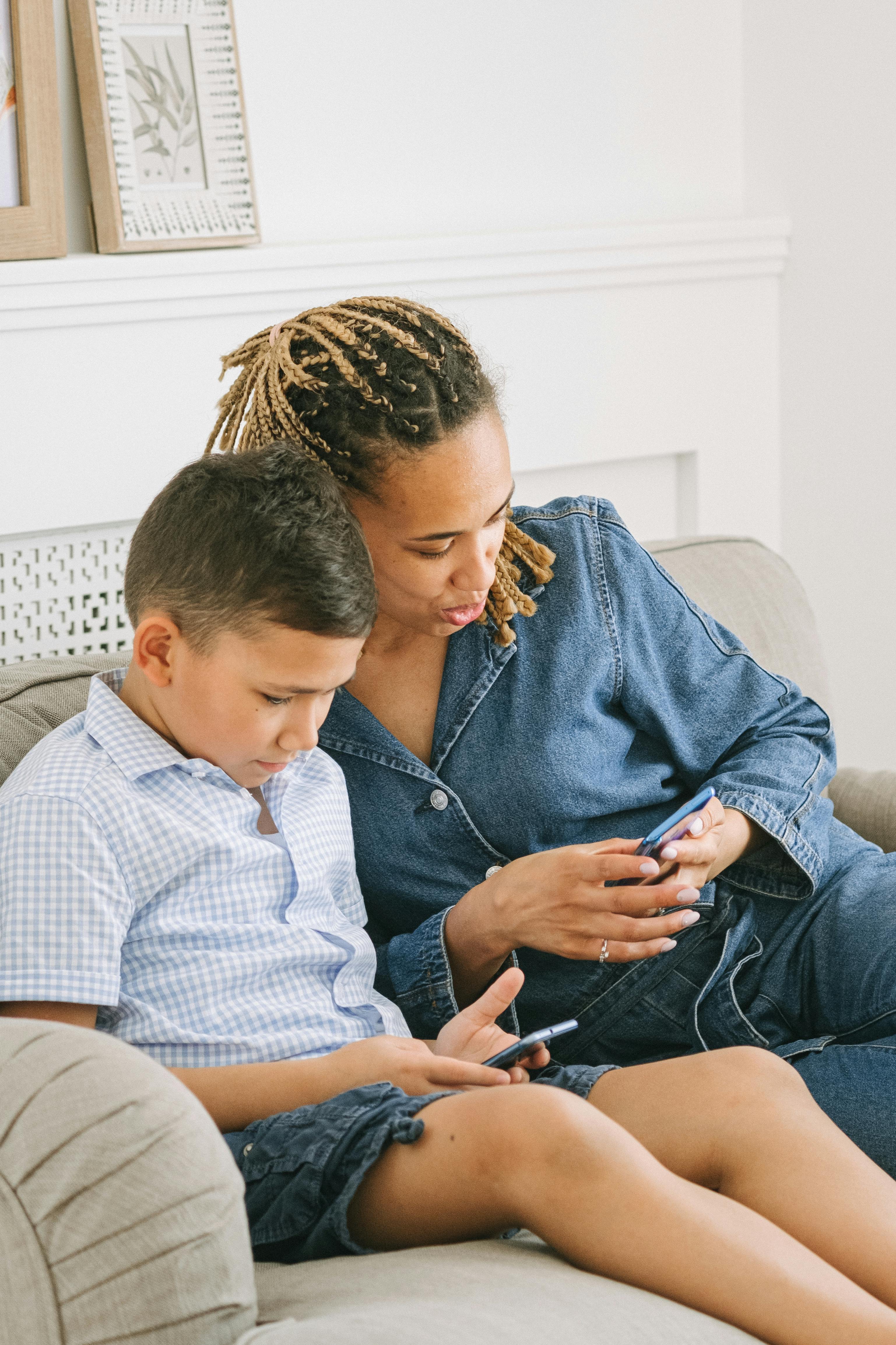 Boy hugging his mother around the waist stock photo - OFFSET