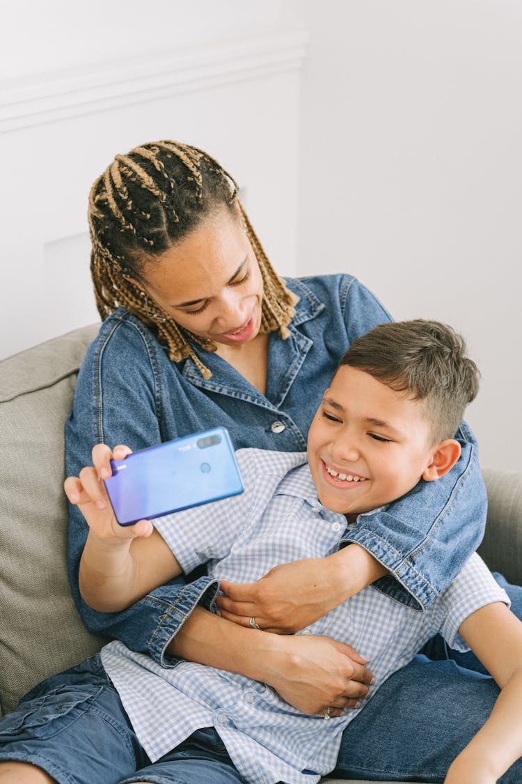 Young Boy With Woman Taking A Selfie