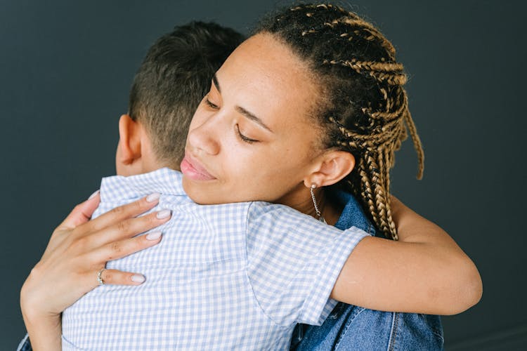 Photograph Of A Woman Hugging Her Son