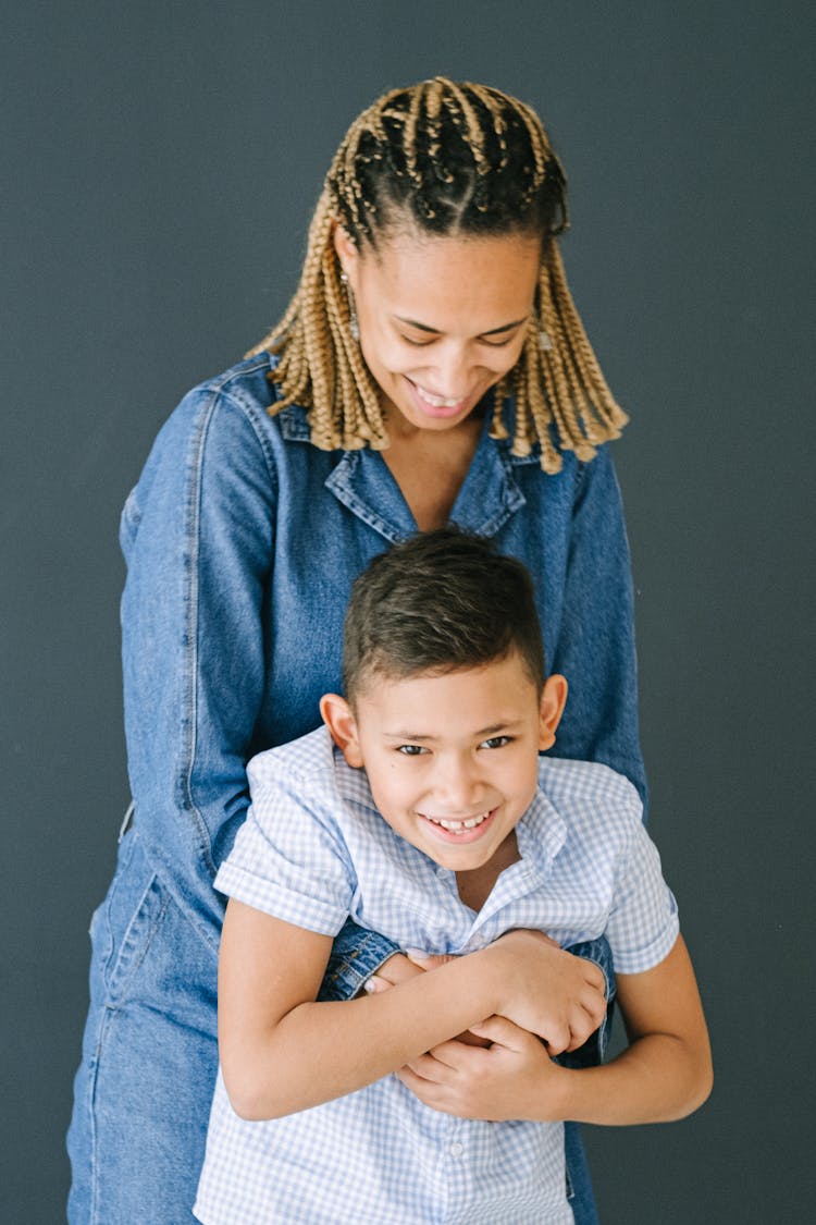 Woman Hugging Son From Behind