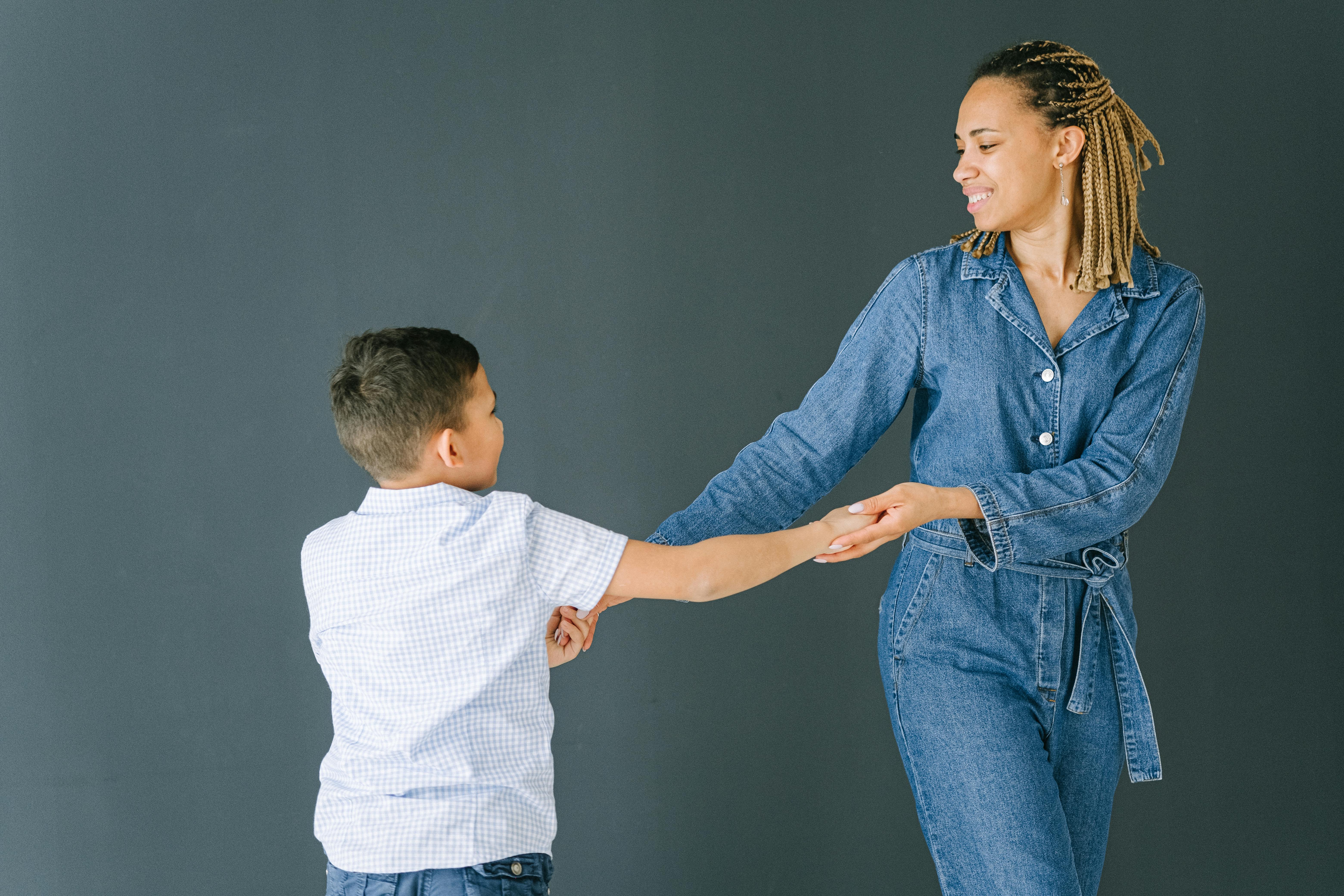 woman and boy holding hands while dancing