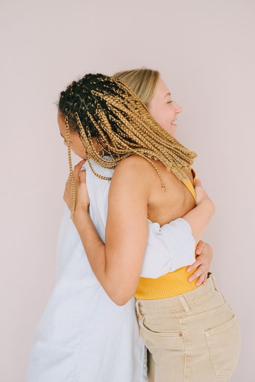 Free Two women joyfully embracing, symbolizing friendship and love. Stock Photo