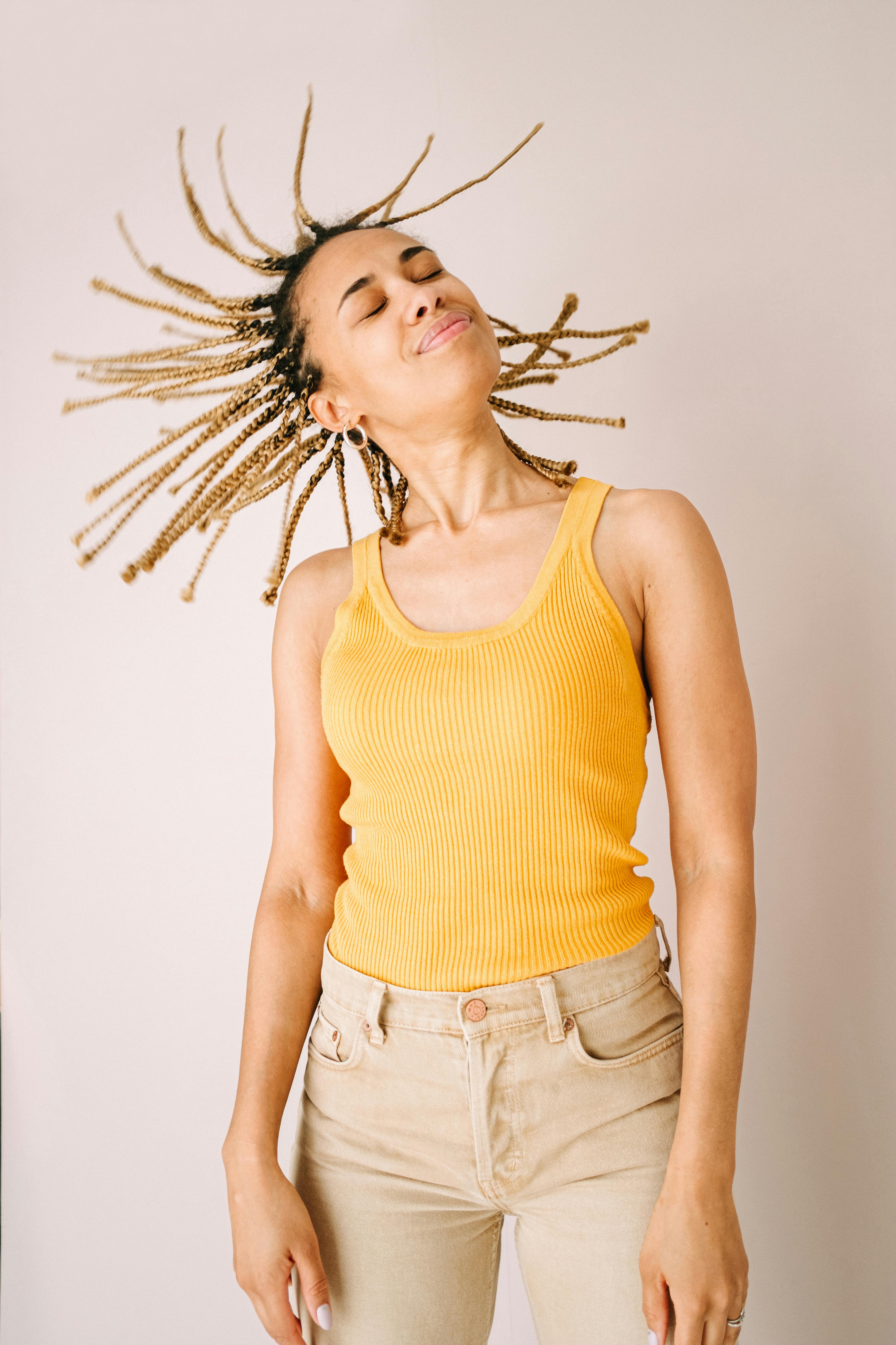 woman in yellow tank top and blue denim shorts