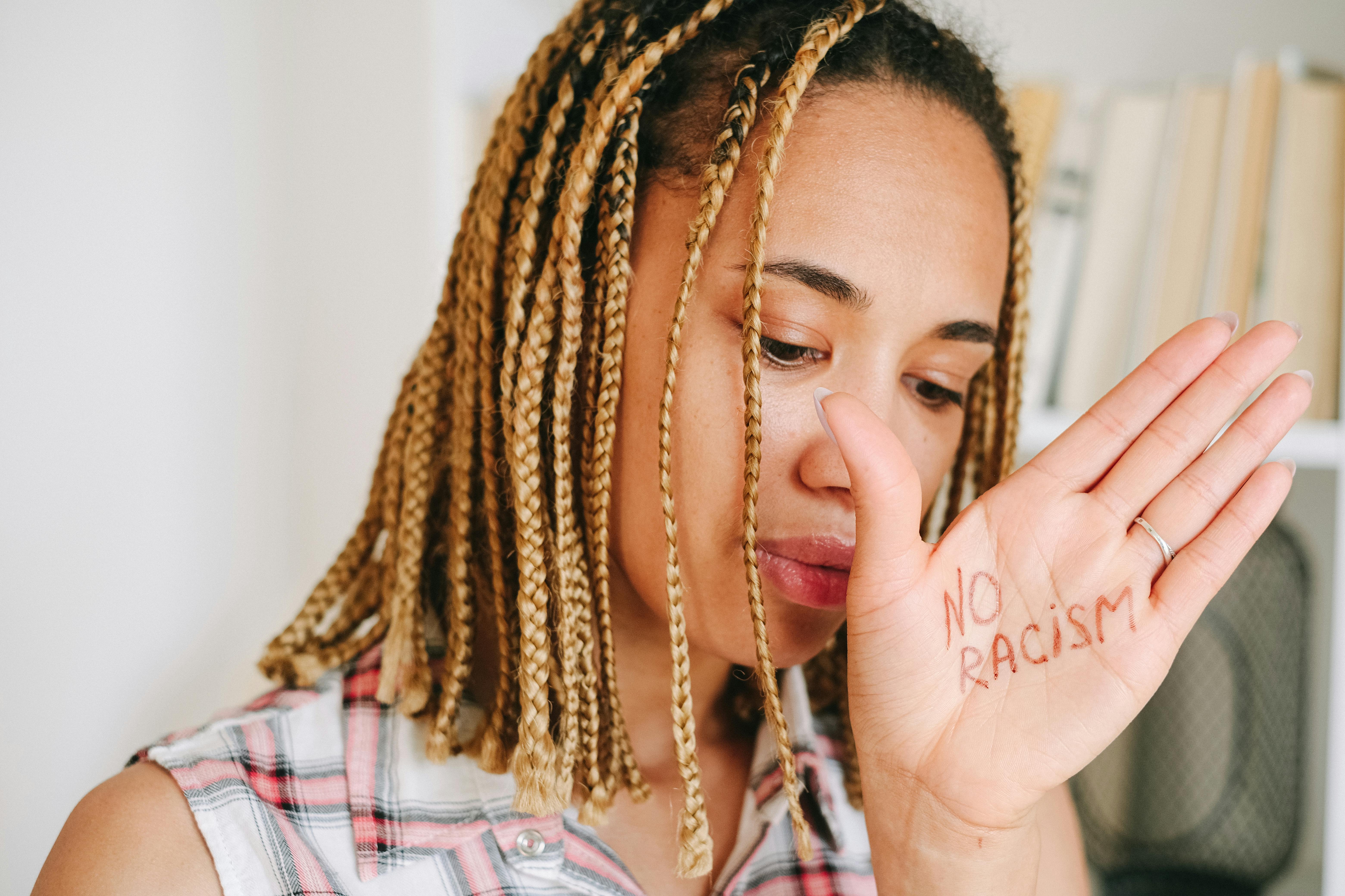 woman in white and red plaid shirt with brown braided hair