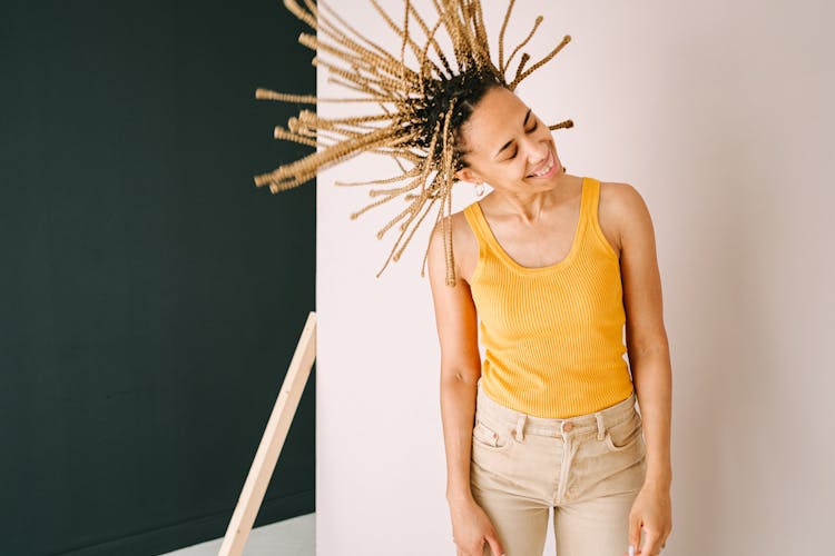 A Woman With Braided Hair Doing A Hair Flip