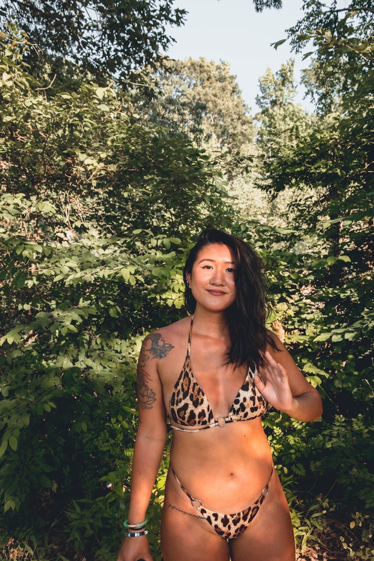 Ethnic Woman In Summer Swimsuit In Greenery