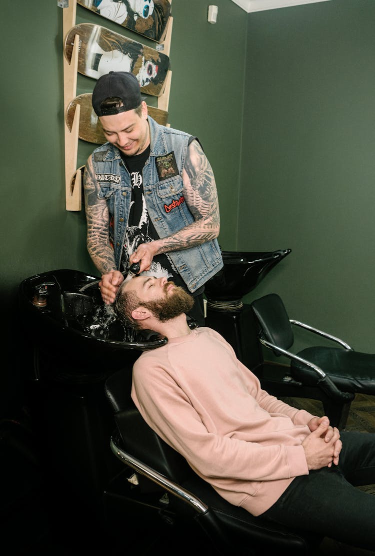 A Barber Shampooing His Customer