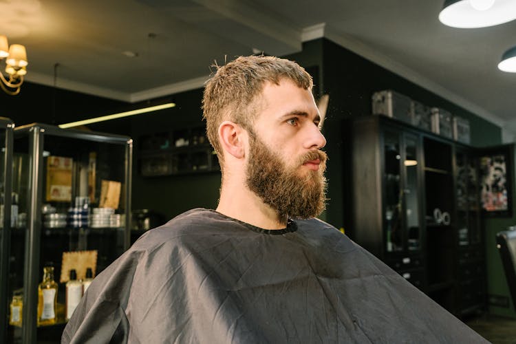 Portrait Of Man Sitting In Barbershop Chair