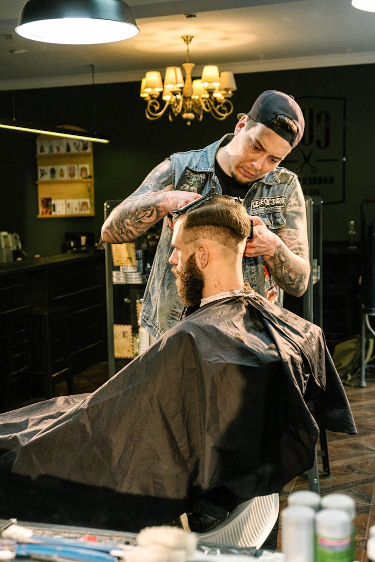 Man Giving His Customer A Haircut