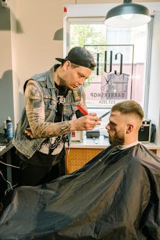 A barber skillfully trims a male client's beard in a stylish barbershop with a modern vibe.