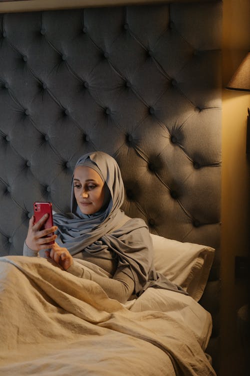 Woman in Brown Hijab Holding Red Box