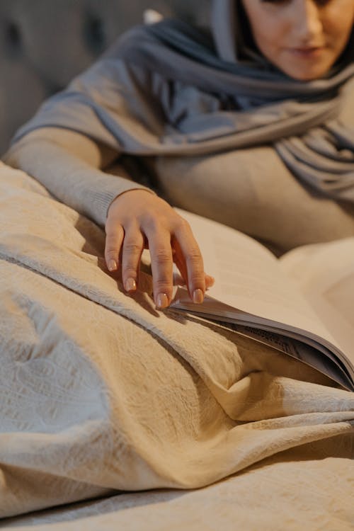 Free Person in Gray Jacket Lying on Bed Stock Photo