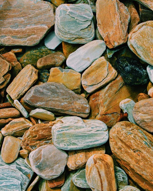 Textured background of colorful dry stones in daylight