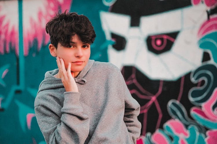 Stylish Male Teen Near Graffiti Wall On Street