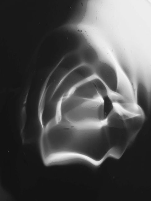 Surreal abstract art featuring shapes and light reflections in black and white.