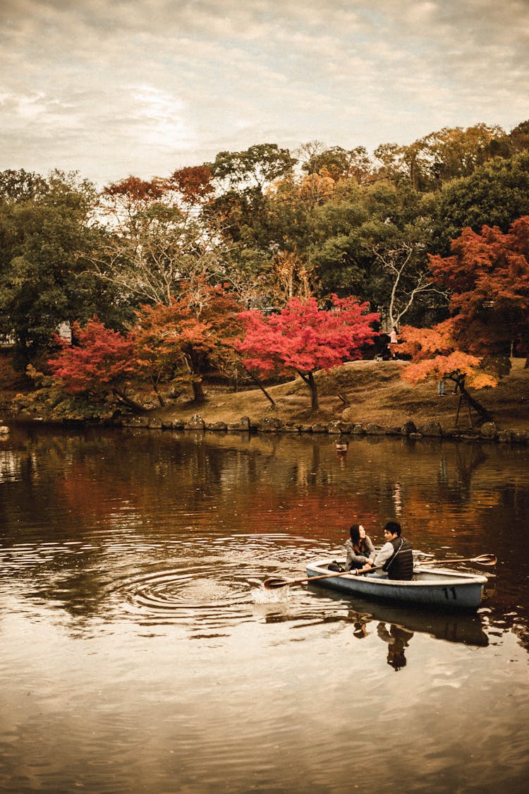 Couple Riding A Boat Together In A Lake