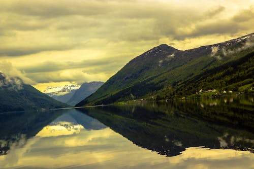 Reflective Photography of Mountain and Body of Water