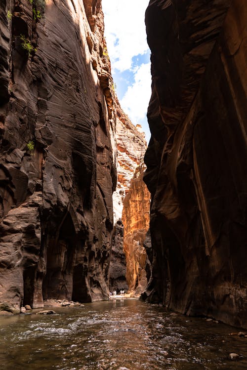 Water Flowing Between Brown Rocky Walls