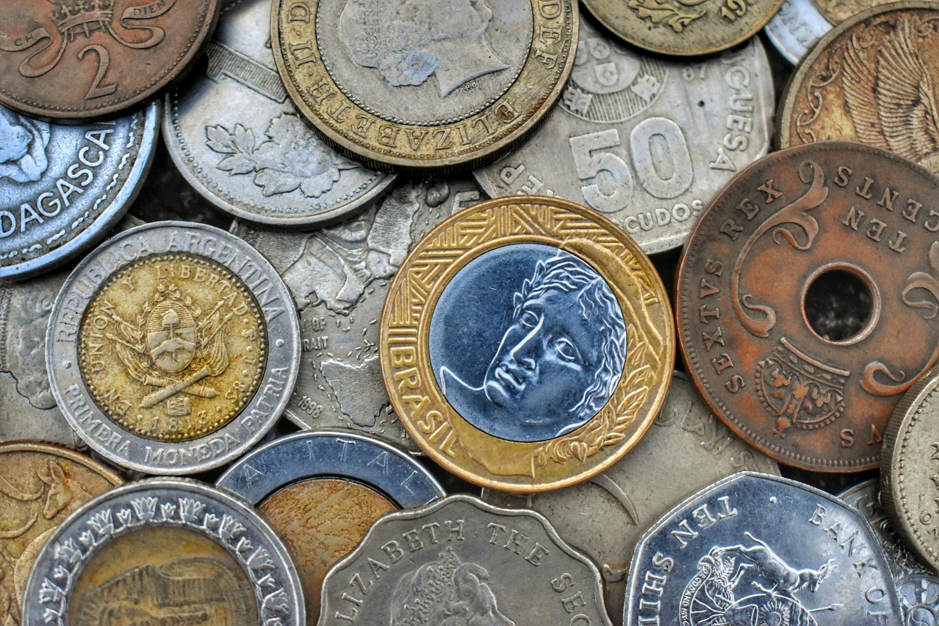 Top view of set of bright old metal coins with etchings and inscriptions with numbers