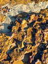 Top view abstract textured background of brown rocky surface under clear transparent water