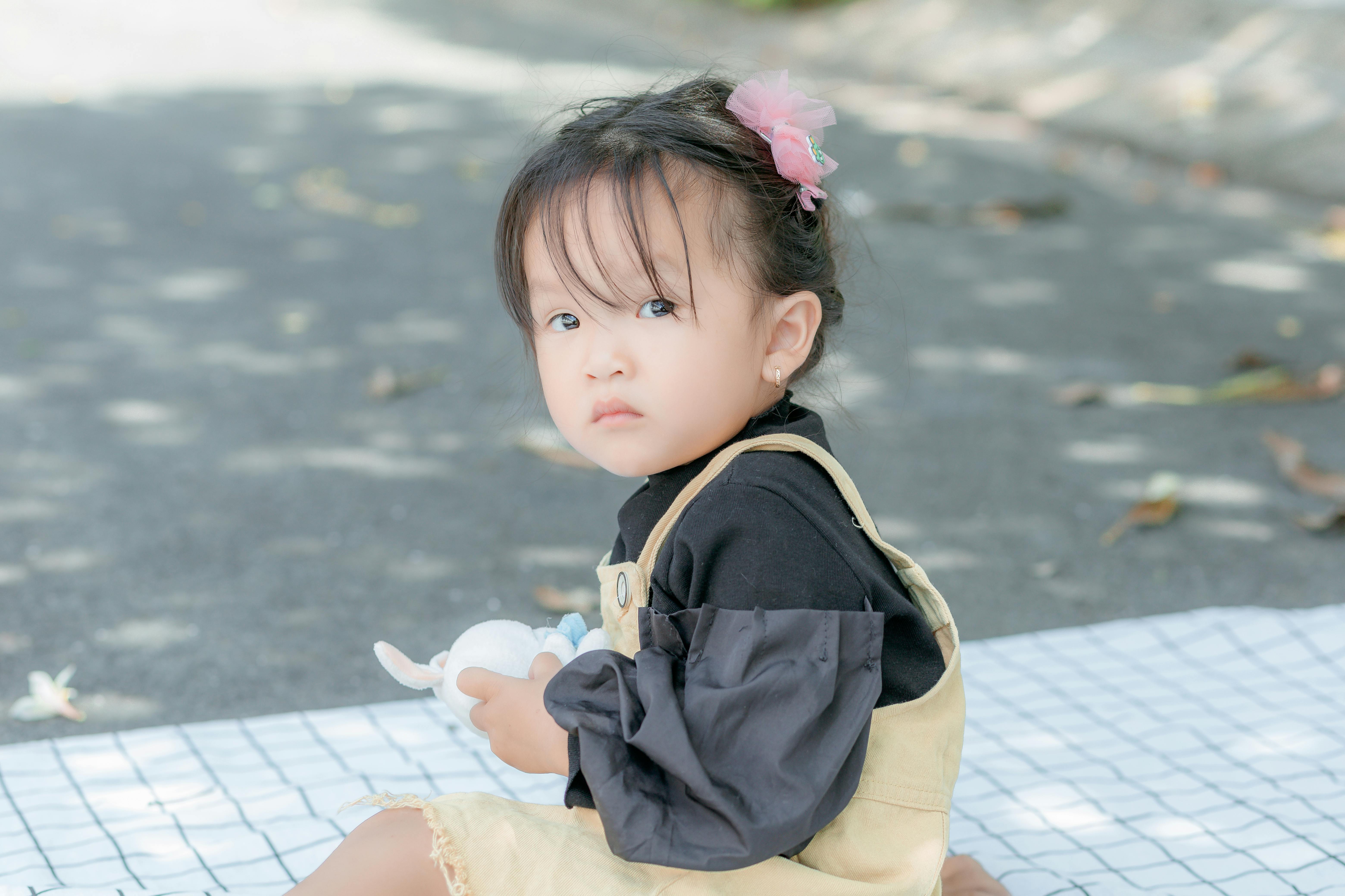 young asian woman wearing a white plaid scarf - Playground