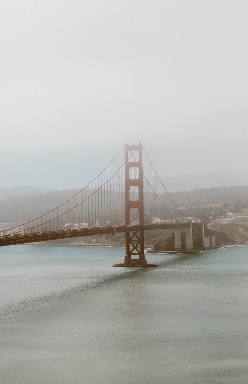 Golden Gate Bridge tower emerging from fog