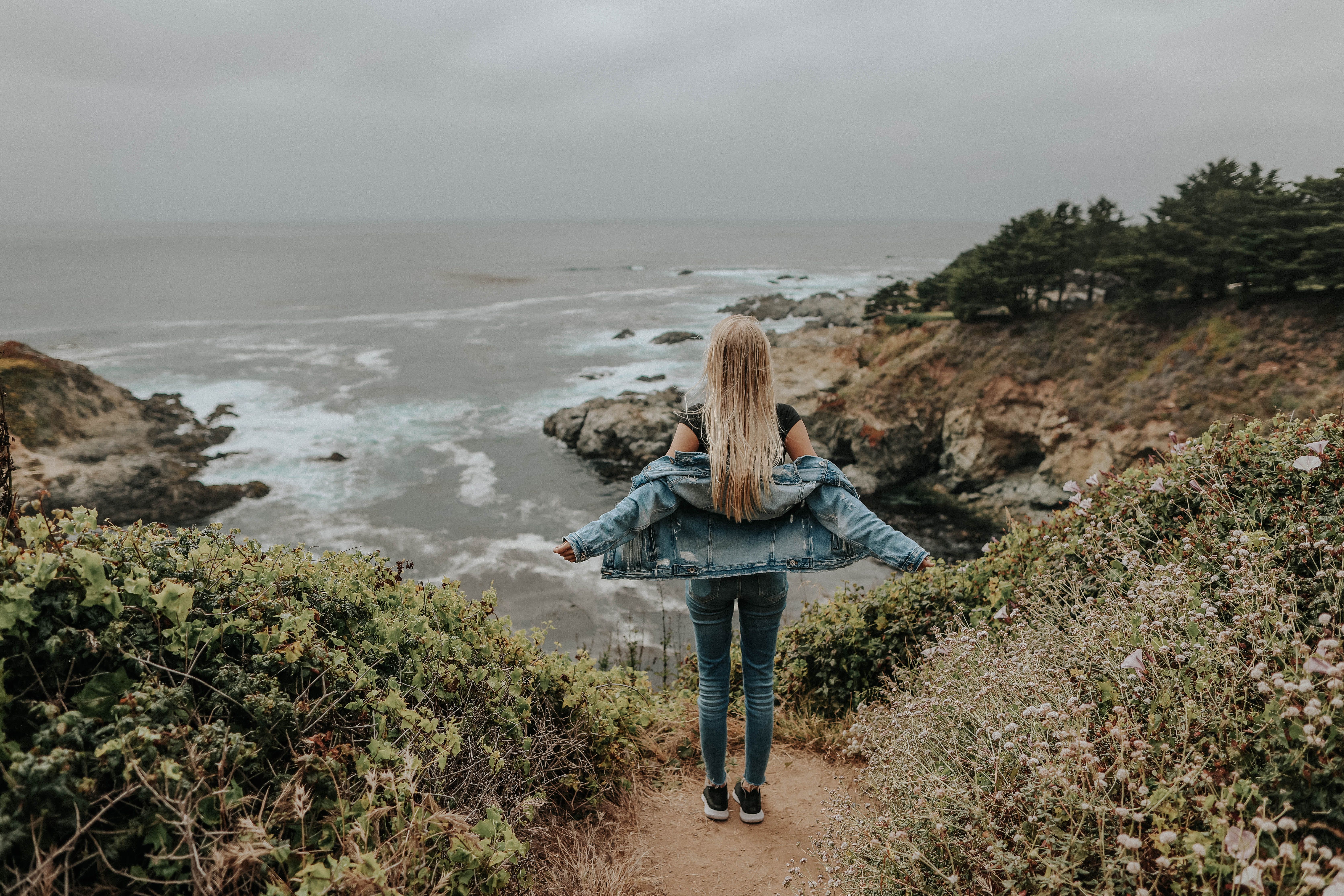 Back View Of Woman in Blue Denim Jacket and Blue Denim Jeans Standing ...