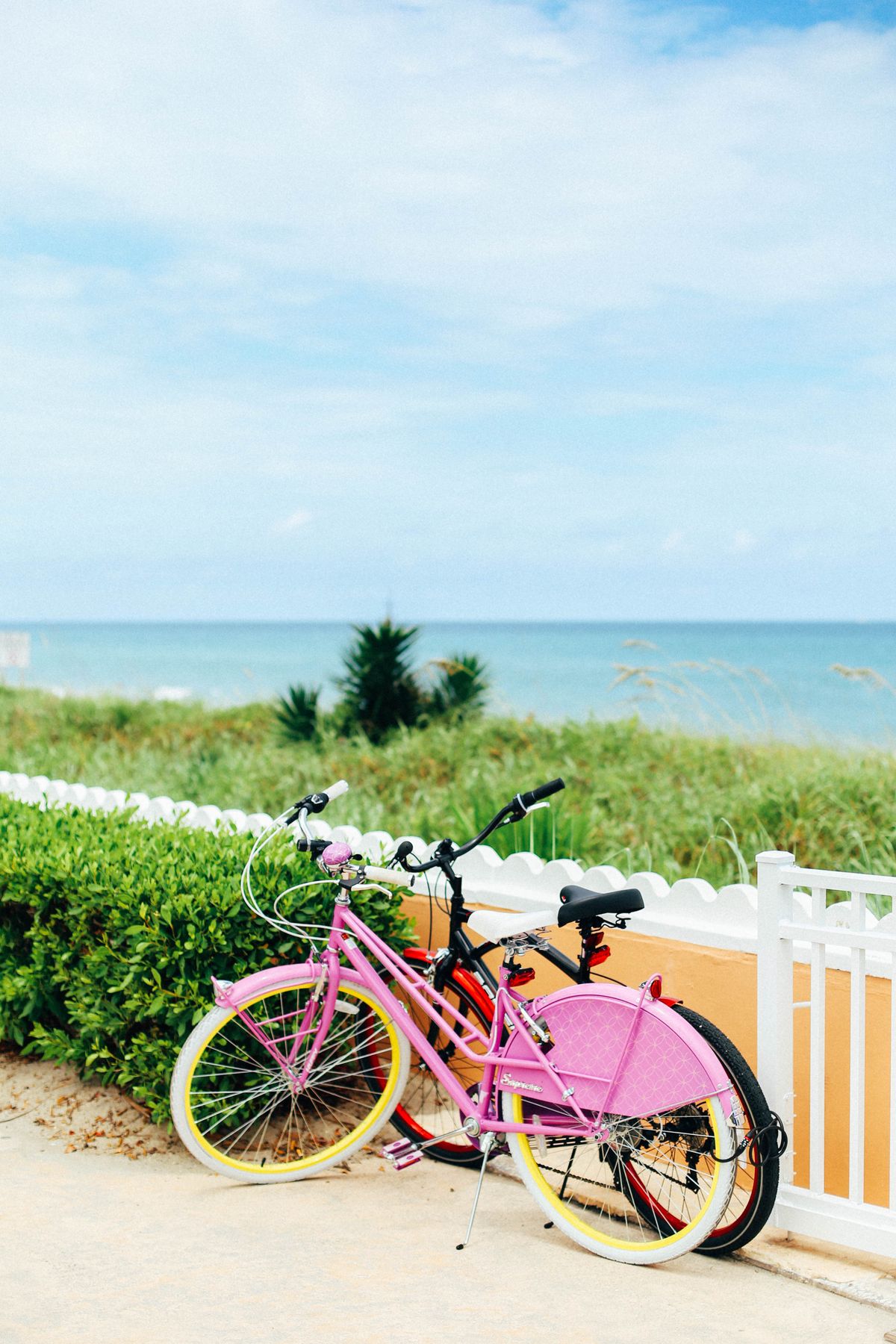 E-Bike Accessories Netherlands 2026 — cruiser bicycles parked on a wooden boardwalk overlooking the beach