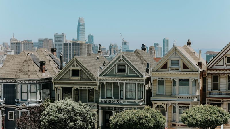 Captivating view of San Francisco's famous Victorian houses with city skyline in the background.