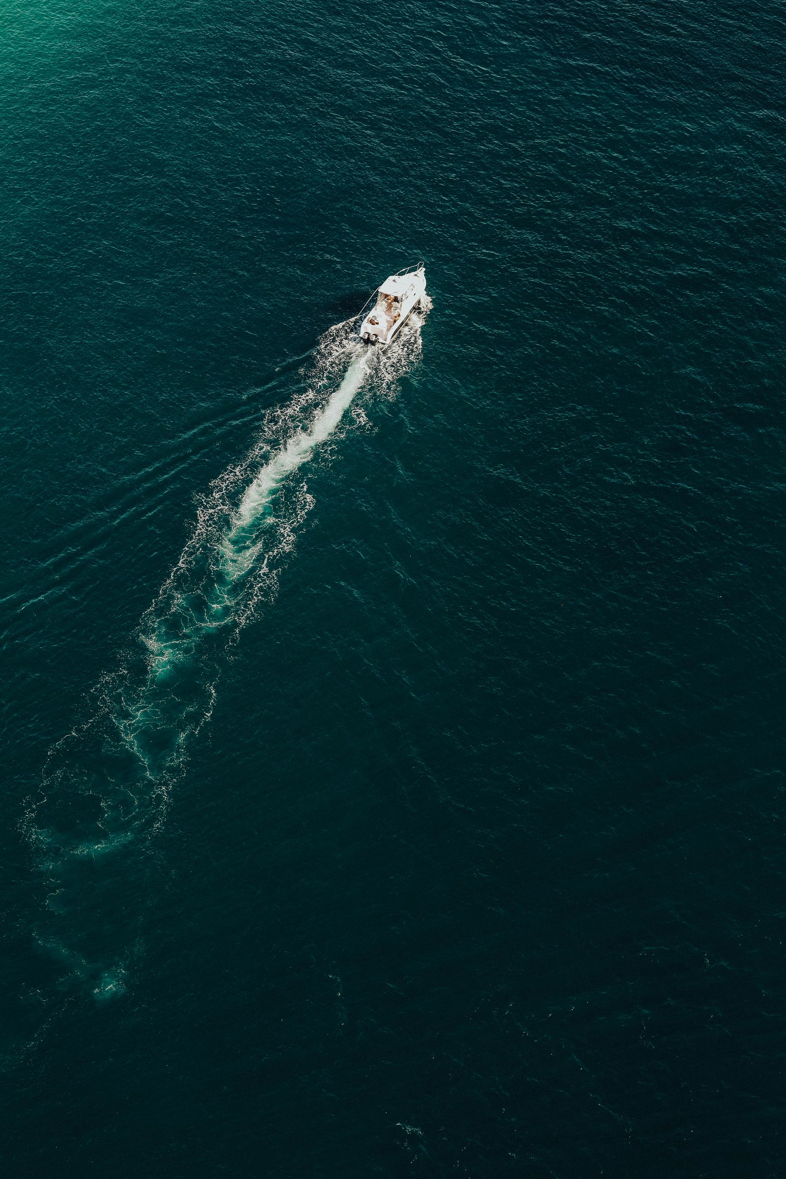 Yacht cruising open water, seen from above