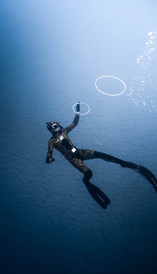 Free Diver in deep blue water Stock Photo