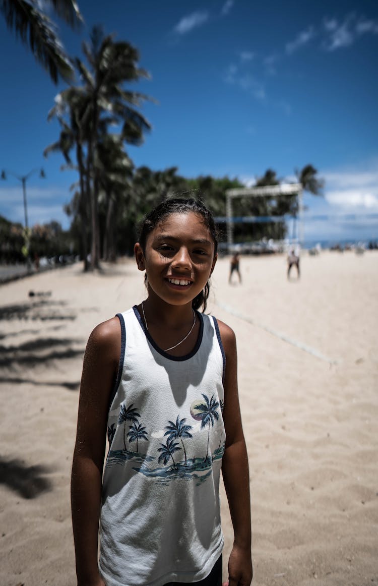 Cheerful Black Girl Standing On Sunny Beach