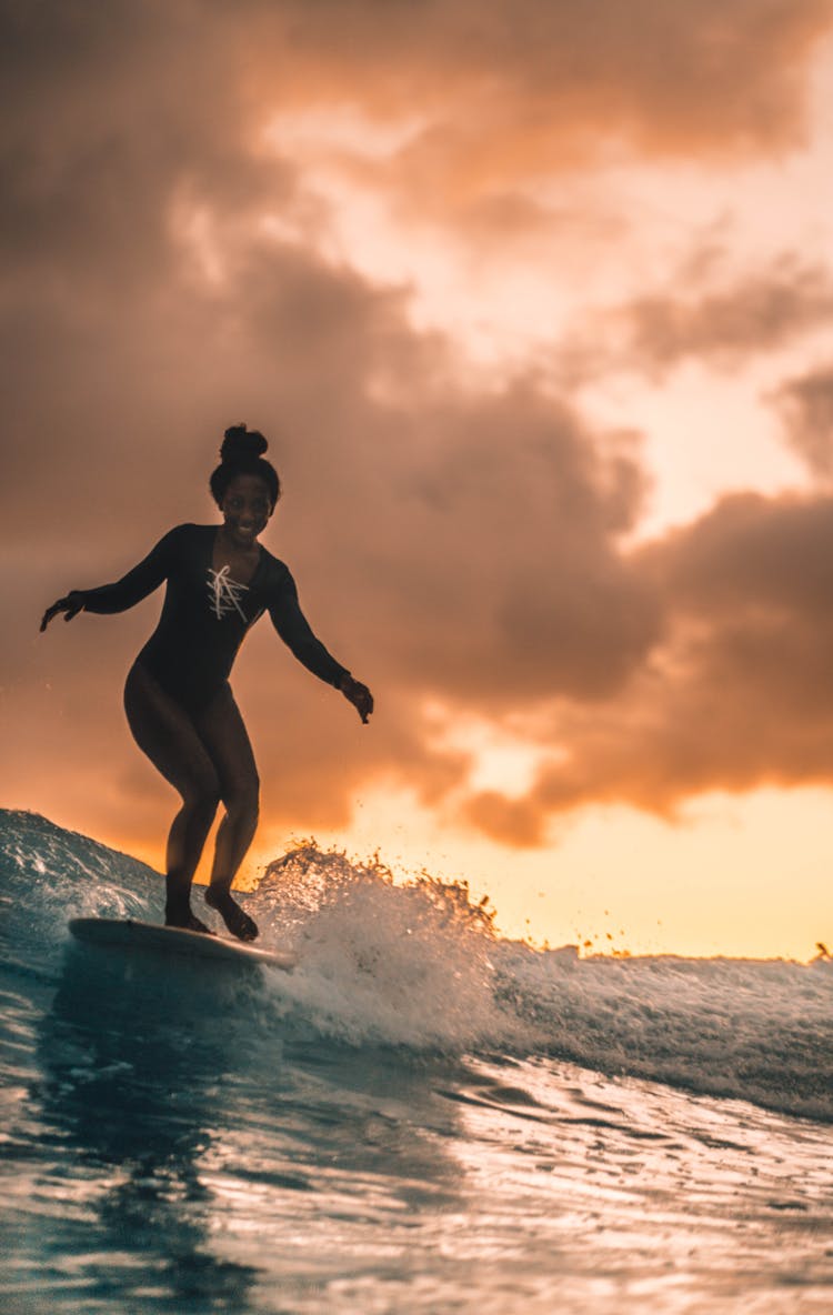 Excited Black Woman Surfing On Board On Sea Waves