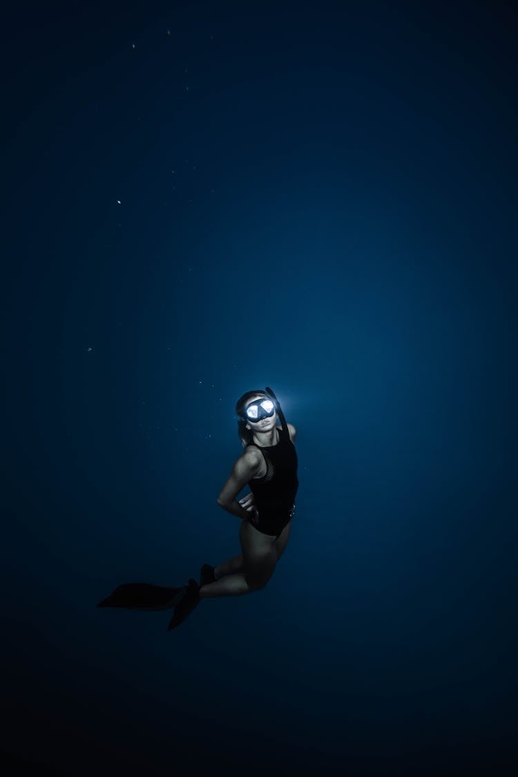 Unrecognizable Woman Diving In Blue Sea Water