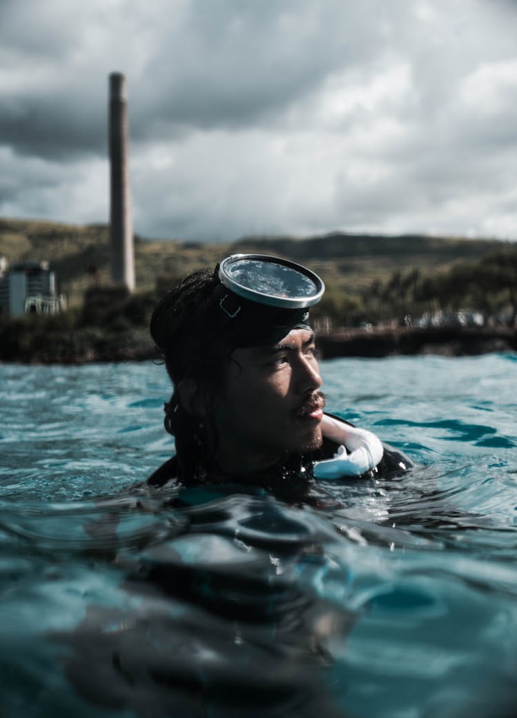 Focused Asian Man Swimming In Sea After Diving