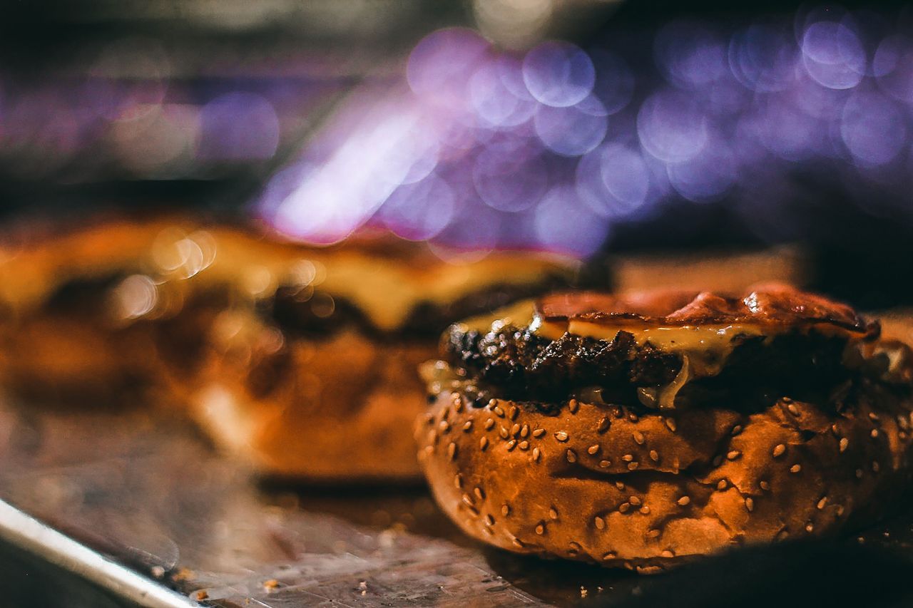 mouthwatering close up of a juicy cheeseburger with a bokeh background