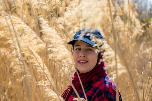 Woman Wearing a Blue Cap in a Wheat Field