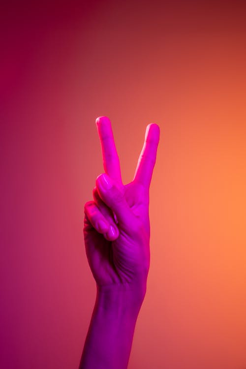 Free Person Doing Peace Sign Hand Gesture Stock Photo