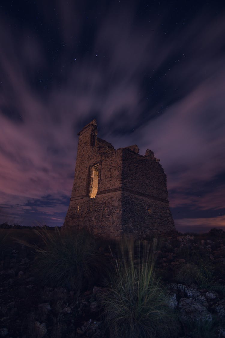 Ruined Medieval Castle Against Purple Night Sky