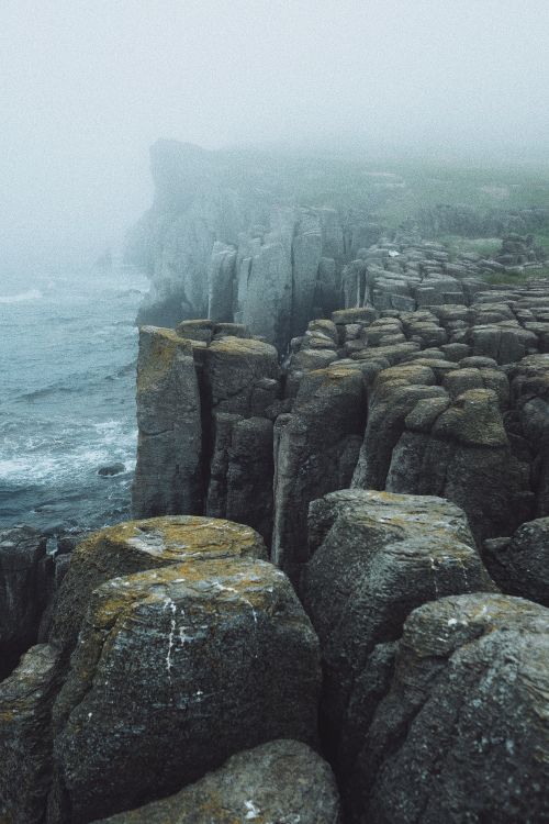 Rugged coastal cliffs in haze, photo by Nadezhda Moryak on Pexels