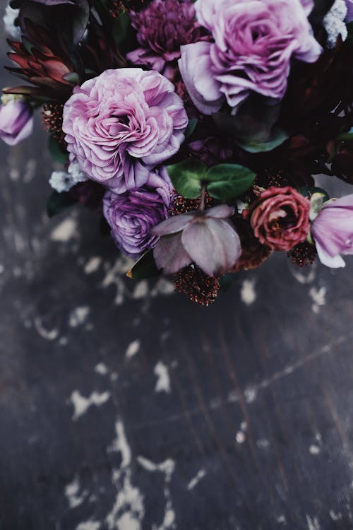 Free Pink And Purple Flowers on Black Wooden Table Stock Photo