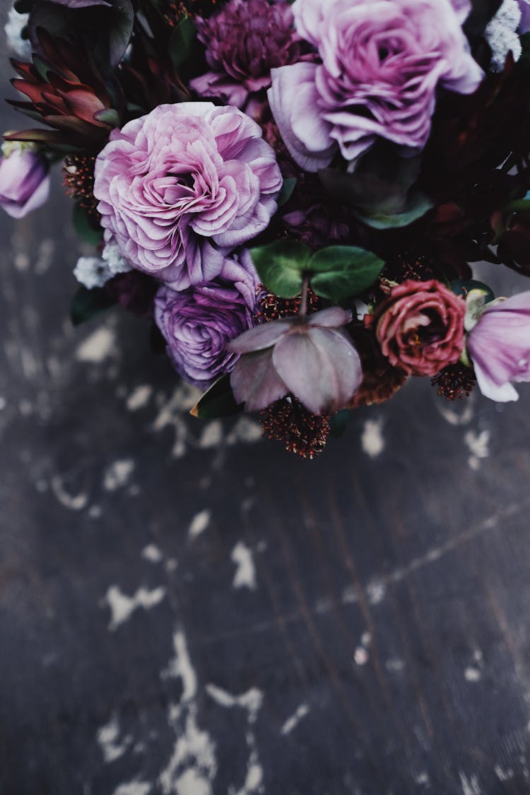 Pink And Purple Flowers On Black Wooden Table