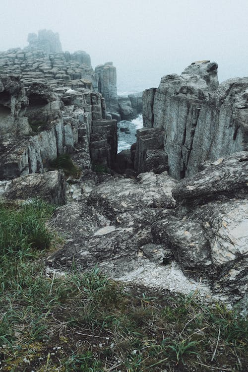 Gray Rock Formation Near Body of Water