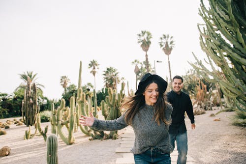 Free Couple Having Fun In A Field Of Cactus Plants Stock Photo