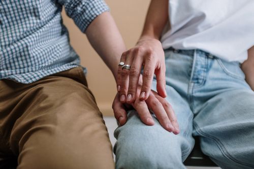 Free A touching moment captured between two people holding hands, symbolizing support and love. Stock Photo